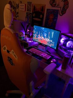 a computer desk with two monitors and a keyboard in front of the monitor is lit up by purple lights