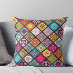 a colorful pillow sitting on top of a couch