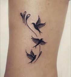 a small tattoo on the side of a woman's lower body, with two birds flying