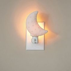 a white wall mounted light with a moon on it