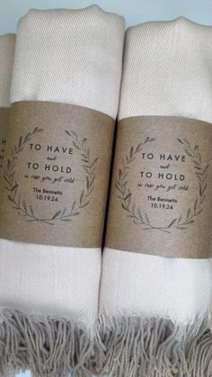 two white towels with brown labels on them