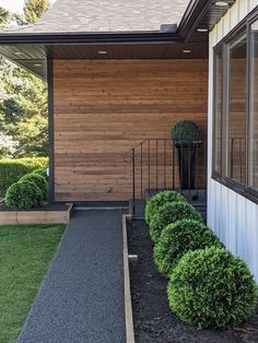 the entrance to a home with wooden siding