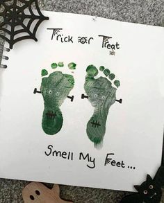 a hand and foot print on a piece of paper with words trick or treat, smell my feet