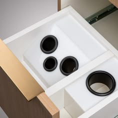 three speakers in a box on top of a table