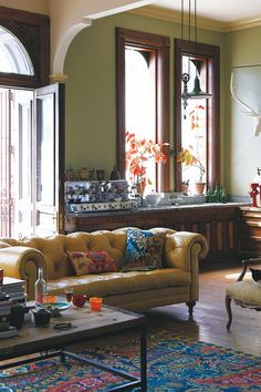 a living room filled with furniture and lots of windows