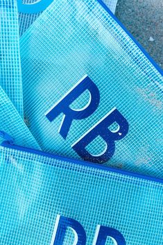 there is a blue bag with the letters bp and p on it sitting next to each other