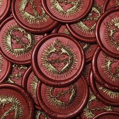 many red buttons with gold designs on them are shown in close up view to the center