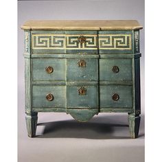 an antique dresser with greek designs painted on the top and bottom drawers, in green