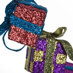 two presents are wrapped in sequins and tied with ribbons on top of each other