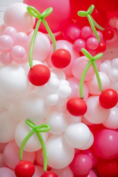 balloons and cherries are floating in the air