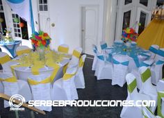 tables and chairs are set up for an event with bright colored sashes on them