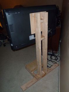 a tv stand made out of pallet wood with a flat screen television on top