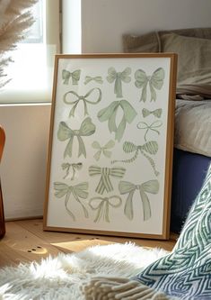 an art print with bows is on the floor next to a chair