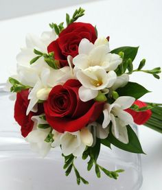 red and white flowers in a clear vase