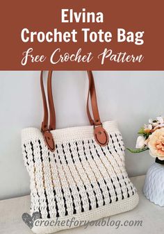 a crochet tote bag sitting on top of a table next to flowers