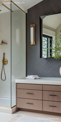 a bathroom with a sink, mirror and shower stall in it's own area