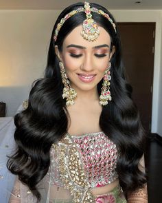 a woman with long black hair wearing a bridal outfit