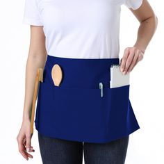 a woman wearing a blue apron with a wooden spoon in her pocket and a clipboard