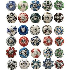 a bunch of different colored glass knobs on a white background