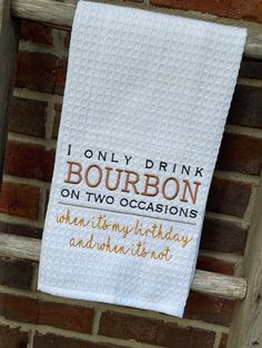 a white towel hanging on the side of a brick wall that says, i only drink bourbon on two occasions