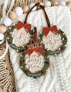 two christmas wreaths with words on them sitting next to some eggs and other decorations