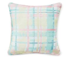 a blue and pink plaid pillow on a white background