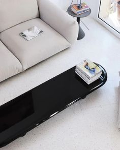 a living room with a white couch and black coffee table