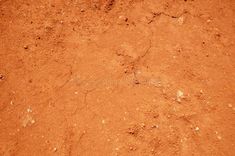 an orange dirt surface with small holes in the middle stock images, textures and backgrounds