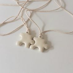 The Ceramic Puzzle Matching Necklaces are a perfect gift for friends or couples! This set of two necklaces features adorable ceramic puzzle pieces that fit together, symbolizing the strong bond you share. Thoughtful and meaningful, they make a sweet accessory to celebrate friendship or love. Perfect for: Anniversaries Best Friend Gifts Couples Family Members ---- Details ---- Set Includes: 2 matching necklaces, each in separate packaging Cord Length: 47 inches (120 cm) Pendant Size: 1.25 inches Couple Ceramics Ideas, Couples Clay Ideas, Friendship Necklaces For 2, Ceramic Puzzle, Cute Clay Crafts, Small Ceramics, Anniversary Crafts, Matching Friends, Puzzle Piece Necklace