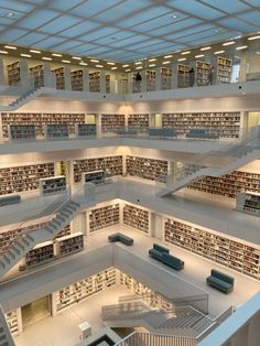 an overhead view of a library with many bookshelves and stairs leading up to the second floor