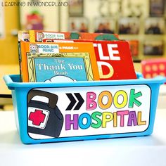 a blue plastic container filled with books on top of a white table next to other children's books