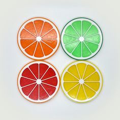 four slices of orange, lemon, and grapefruit are arranged in the shape of circles