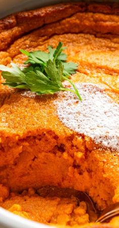 a close up of food in a bowl with a fork and spoon on the side