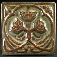 a square tile with an intricate design on it