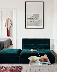 a living room with a green couch and coffee table