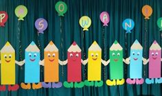 some paper crayons are lined up with balloons