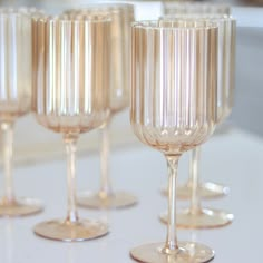 four champagne glasses lined up on a table