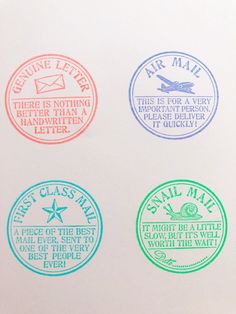 four different colored stamps on a white surface