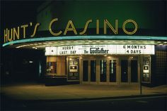 a movie theater with the words hunt's casino lit up in front of it