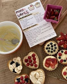 some desserts are sitting on cooling racks next to a bowl of yogurt