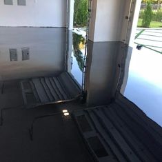 the inside of a house with water on the floor