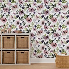 the wallpaper in this room is painted with pink flowers and green leaves, along with wicker baskets