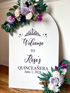 a welcome sign with purple and white flowers