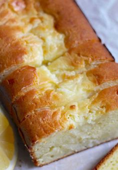 a loaf of lemon pound cake next to a slice of lemon