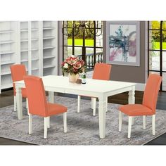 a white table with orange chairs in front of it