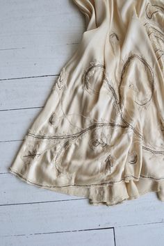 "Antique 1920s cream silk charmeuse dress with cream lace filled cutouts outlined with pearls, classic 1920s simple shape and drop waist and side metal hook and eye closures. [m e a s u r e m e n t s] fits like: extra small/small bust: best fit up to 32.5\" waist: best fit up to 26\" hip: free length: 42\" [i n f o] brand/maker: n/a fabric content: silk condition: excellent (very faint underarm discoloration), and a break in the lace on the skirt, see close up. to ensure a good fit, please read Ivory Slip Dress, Wedding Dress Silk, 20s Dress, 1920s Wedding Dress, Silk Charmeuse Dress, Charmeuse Dress, 1920s Wedding, Silk Wedding Dress, Cream Silk