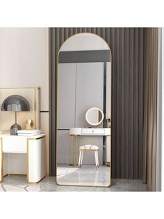 a large mirror sitting on top of a white floor next to a desk and chair