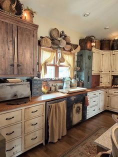 an old fashioned kitchen with lots of cupboards and drawers on the counter top,