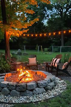 A cozy backyard setup with a stone fire pit, surrounded by chairs, string lights, and trees glowing in the evening light. Simple Fire Pit Area, Outdoor Patio With Fire Pit, Firepits Backyard, Backyard Fire Pit Ideas, Fire Pit Garden, Outside Fire Pits, Cozy Gathering, Backyard Fire Pit, Fire Pit Swings