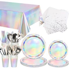 a table setting with holographic plates, napkins and place settings in iridescent colors